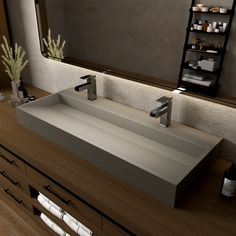 a bathroom sink sitting on top of a wooden counter next to a mirror and shelf