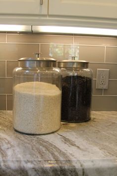 there are two jars on the kitchen counter