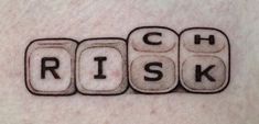 the word risk spelled with dices in black ink on a man's stomach