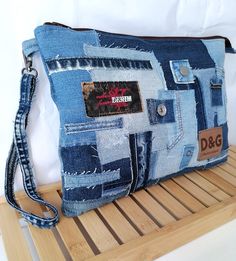 a purse made out of old jeans is sitting on a wooden shelf