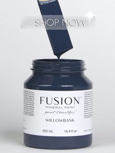 a bottle of blue paint with the words fuson painted on it's side