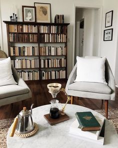 a living room filled with furniture and books