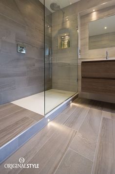 a bathroom with a glass shower door and wood flooring on the walls is featured in an instagram