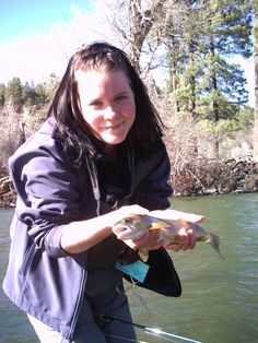 a woman holding a fish in her hands