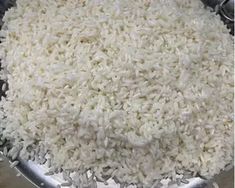 white rice is in a large metal bowl