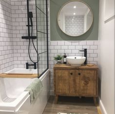 a bathroom with a sink, mirror and bathtub next to a shower stall in the corner