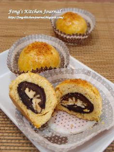 three pastries sitting on top of a white plate next to each other in plastic wrappers