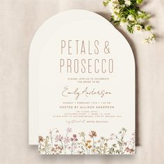 a wedding card with flowers on it and the words petals & prosceco