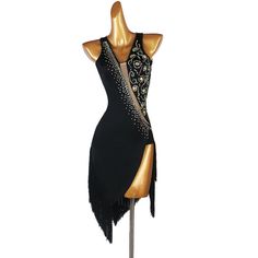 a mannequin wearing a black dress with beading and fringes on it