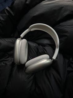 headphones laying on top of a black blanket