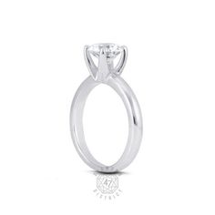 a round cut diamond engagement ring in white gold with the center stone set at the top