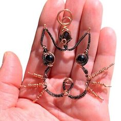 three pieces of jewelry are in the palm of someone's hand