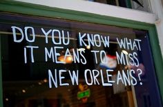 a window with writing on it that says do you know what it means to miss new orleans?