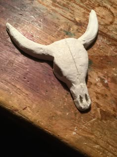 an animal skull is laying on a wooden table