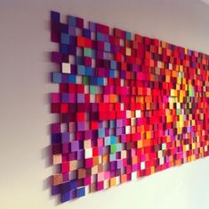 a large colorful piece of art hanging on the wall