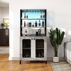 a living room with a couch, table and shelves filled with liquor bottles on top of it