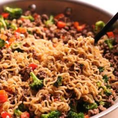 a bowl filled with noodles, broccoli and meat