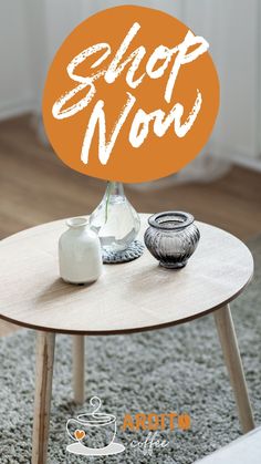 an orange sign that says shop now on top of a coffee table