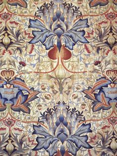 an intricately designed carpet with blue and red colors