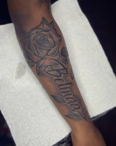 a person with a rose tattoo on their arm