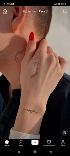 a man and woman kissing each other with tattoos on their hands