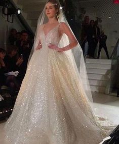 a woman in a wedding dress on the runway