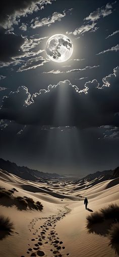 a man walking across a desert under a full moon with footprints in the sand below