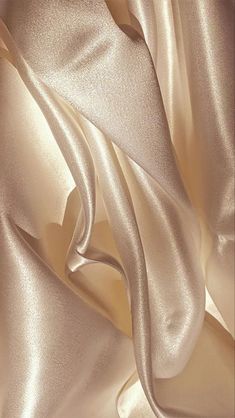 a close up view of a white satin fabric