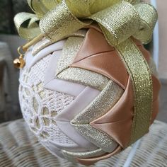 a decorative ornament with gold ribbon on it