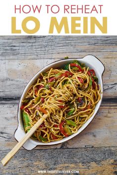 a pan filled with noodles and vegetables on top of a wooden table