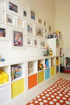 a child's playroom with toys and pictures on the wall