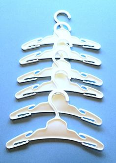 several white plastic hangers on a blue background