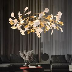 a modern chandelier hanging from the ceiling in a living room