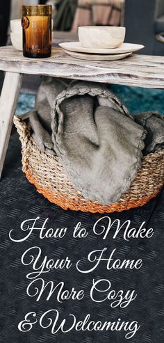 a table with a basket on it and a candle next to it that says how to make your home more cozy and welcoming