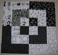 a black and white patchwork quilt with animals on it