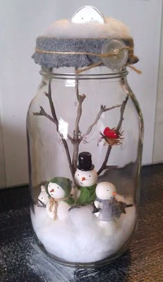 a glass jar filled with flowers and branches