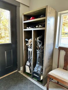 a wooden cabinet filled with golf gear next to a chair