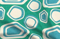 a green and white fabric with blue circles on it's side, in the background