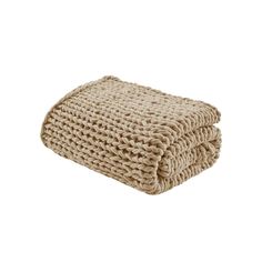 the beige knitted blanket is folded on top of each other, and it's made