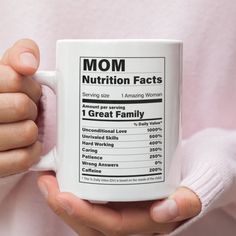 a person holding a coffee mug with nutrition information printed on the front and back of it