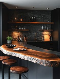 a wooden bar with stools in a kitchen next to a counter top and shelves