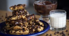 chocolate chip cookies stacked on top of each other with milk and chocolate chips around them