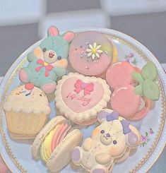 a plate full of decorated cookies and pastries