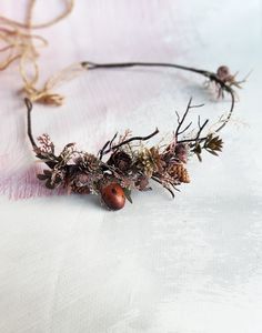 This stunning headdress combines elements of forest nature and will be the perfect addition to your look. composition Size in hair comb  5 * 7 cm Gift wrap included materials: - greenery - cone - acorn - artificial plastic greenery - artificial branch - love Thank you for visiting Please visit my other items. I hope you will find something special and beautiful https://www.etsy.com/shop/Vualia Custom orders are welcome. If you have special wishes, please write a message. Celtic Crown, Fantasy Crown, Artificial Branches, Wedding Bridal Hair, Forest Nature, Autumn Forest, Crown Hairstyles, Pine Cone, Wedding Hair Accessories