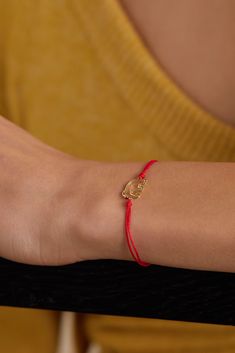 Yvonne Léon's bracelet is discreetly packed with symbolic meaning. Designed with a red cord - said to shield negative energy - this handmade style is strung with an 18-karat gold elephant that represents wisdom, power and strength and has a dainty diamond for an eye. Make it your everyday signature.  Wear it with: [Frankie Shop Blazer id1271096], [Citizens of Humanity Jeans id1204417], [The Row Tank id1009803]. Frankie Shop Blazer, Gold Elephant, Frankie Shop, Citizens Of Humanity Jeans, Gold Silk, Eye Make, Citizens Of Humanity, Handmade Fashion, Watches Jewelry