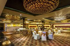 the banquet hall is decorated with gold and white linens