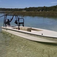 a white boat in the water with a man on it