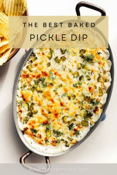 the best baked pickle dip recipe in a skillet with chips on the side