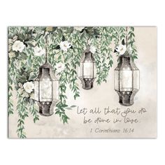 two lanterns with white flowers and leaves on the wall, one is saying let all that you do be done in love