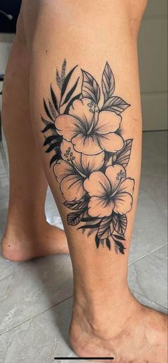 a black and white flower tattoo on the leg